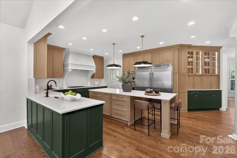 a kitchen with a stove a sink a counter top space and cabinets