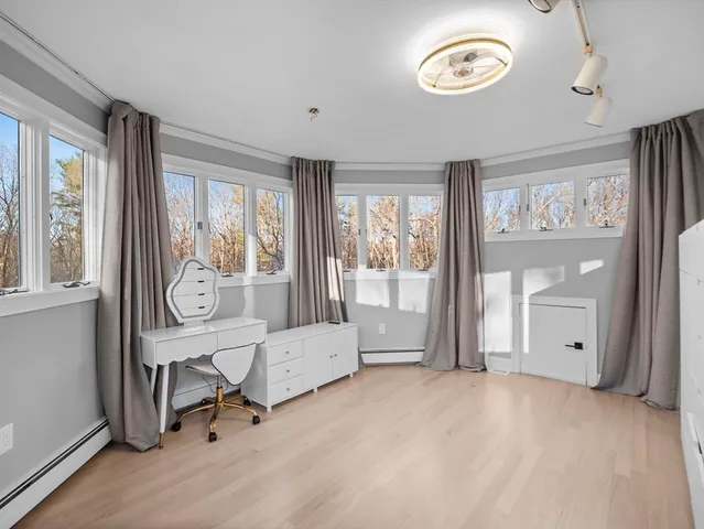 a view of a livingroom with furniture and a window