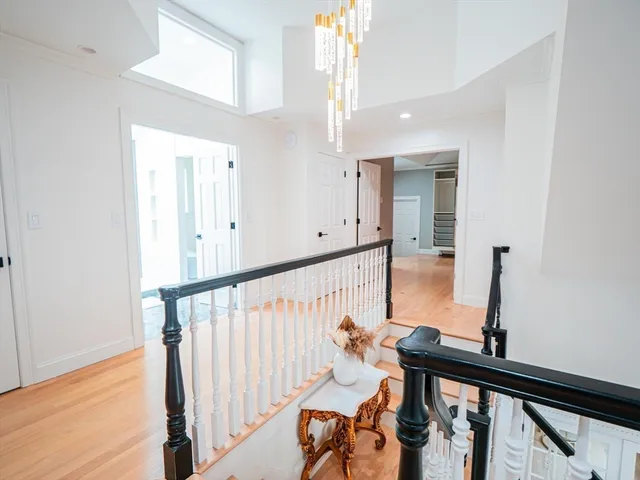 a view of an entryway with wooden floor and mirror
