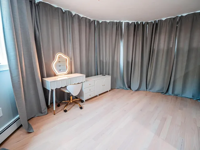 a view of a room with a window and chair