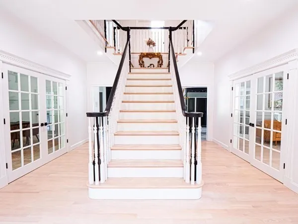 a view of entryway and hall with wooden floor