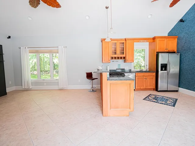 a kitchen with stainless steel appliances granite countertop a stove a sink and a refrigerator