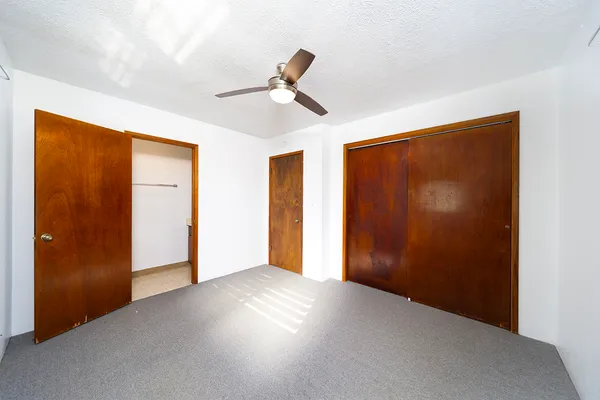 a view of empty room with ceiling fan