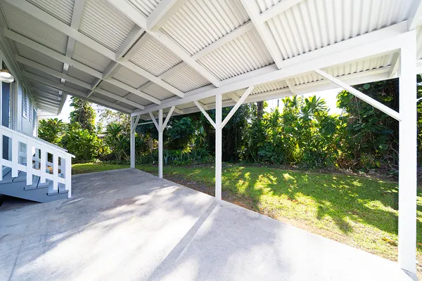 a view of a porch with furniture and garden