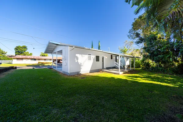 a view of a house with a backyard