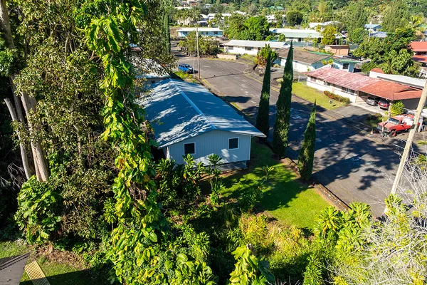 a aerial view of a house with a yard basket ball court and outdoor seating