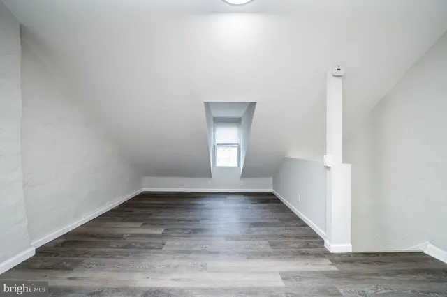 a view of an empty room and wooden floor