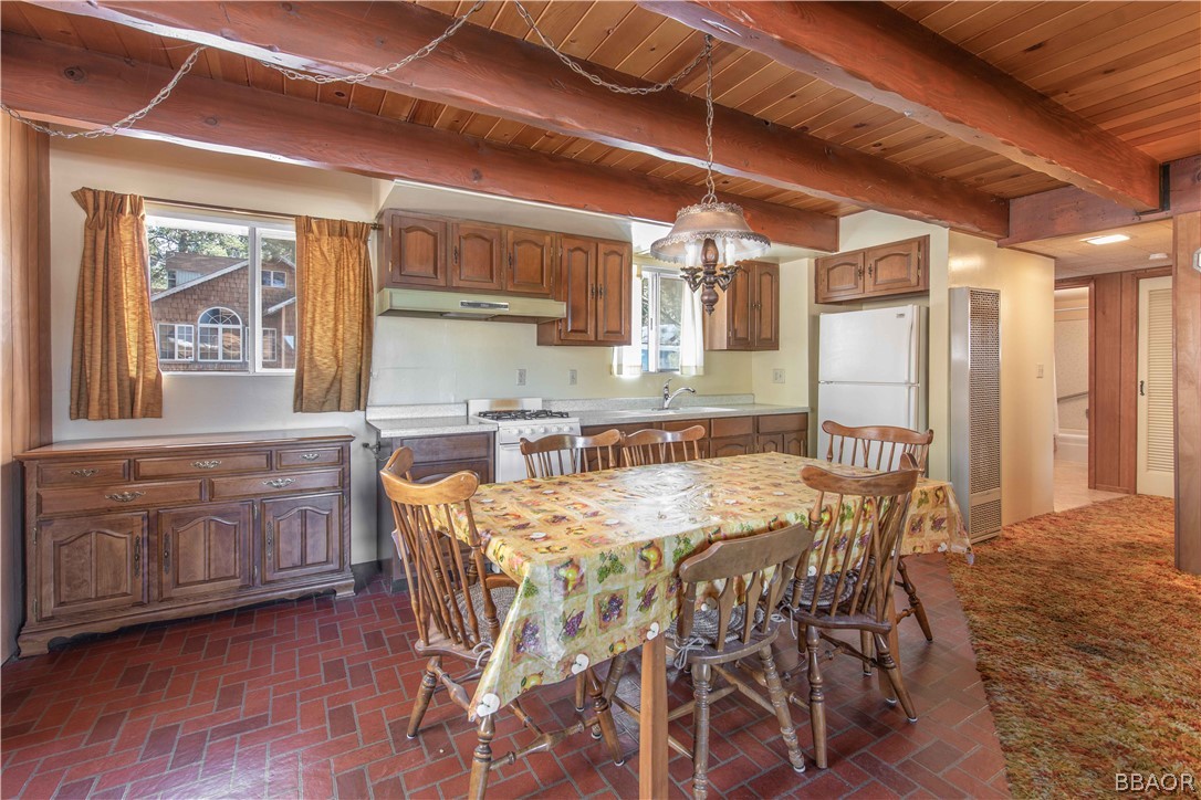458 Edgemoor Road Big Bear Lake, CA 92315 - Photo 15 of 47 a kitchen with stainless steel appliances granite countertop a kitchen island hardwood floor and wooden cabinets