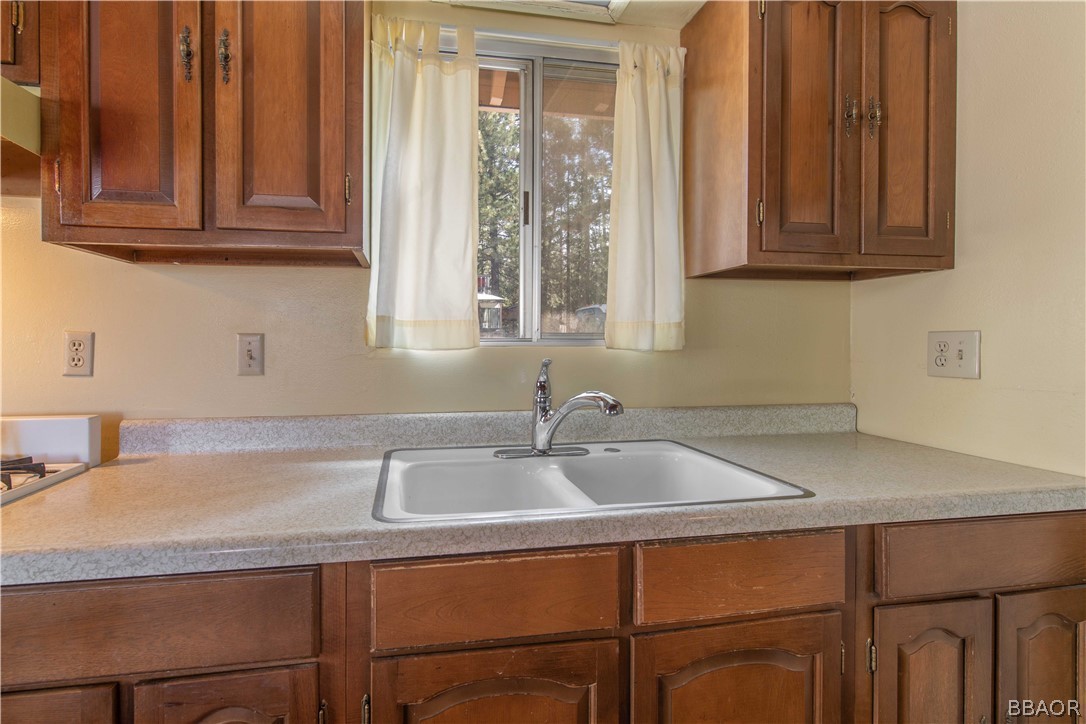 458 Edgemoor Road Big Bear Lake, CA 92315 - Photo 18 of 47 a kitchen with a sink and cabinets