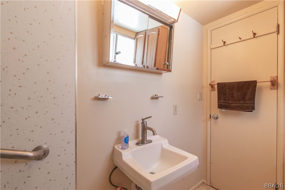 458 Edgemoor Road Big Bear Lake, CA 92315 - Photo 22 of 47 a bathroom with a sink a mirror and shower