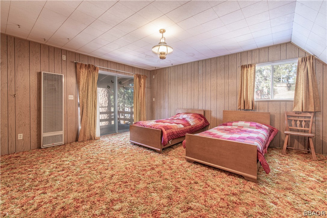 458 Edgemoor Road Big Bear Lake, CA 92315 - Photo 32 of 47 a spacious bedroom with a bed and a chandelier