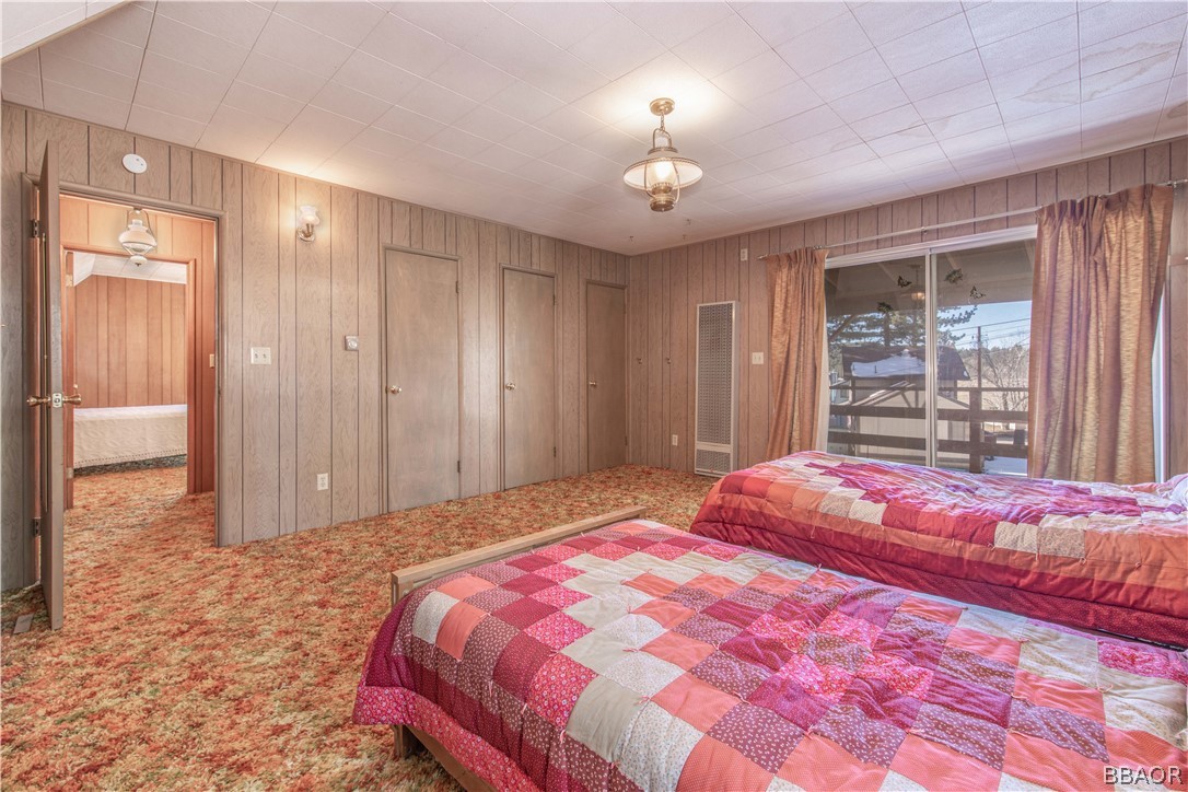 458 Edgemoor Road Big Bear Lake, CA 92315 - Photo 34 of 47 a bedroom with a large bed and a chandelier