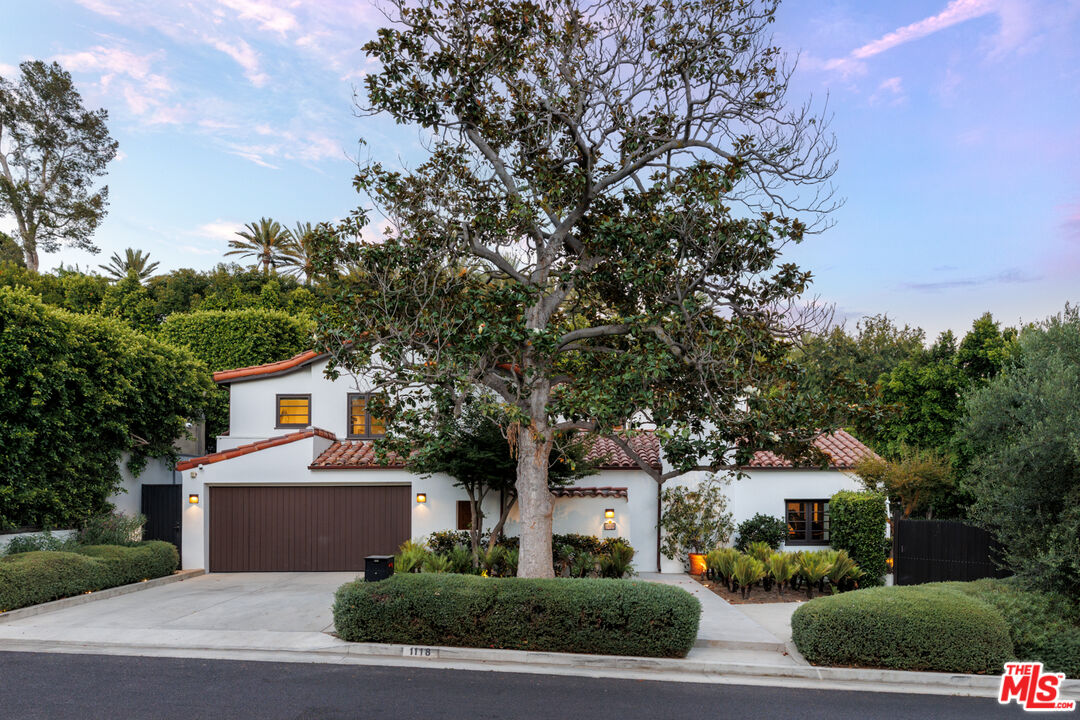 1118 Tower Road Beverly Hills, CA 90210 - Photo 1 of 16 a front view of a house with a garden and trees