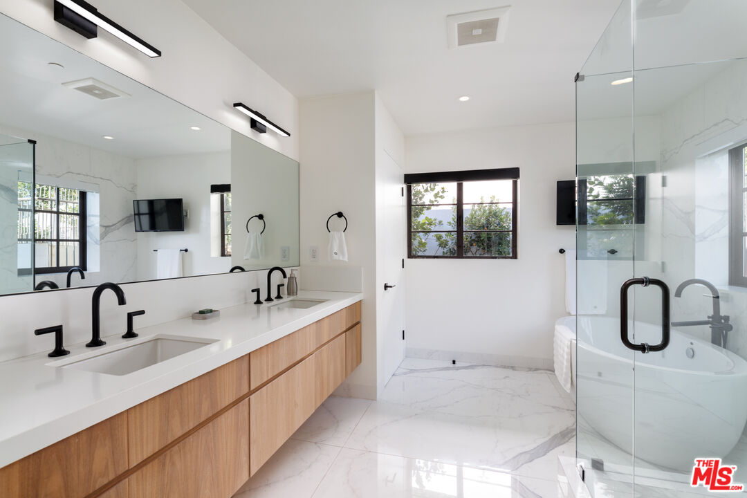 1118 Tower Road Beverly Hills, CA 90210 - Photo 11 of 16 a bathroom with a double vanity sink mirror and bathtub