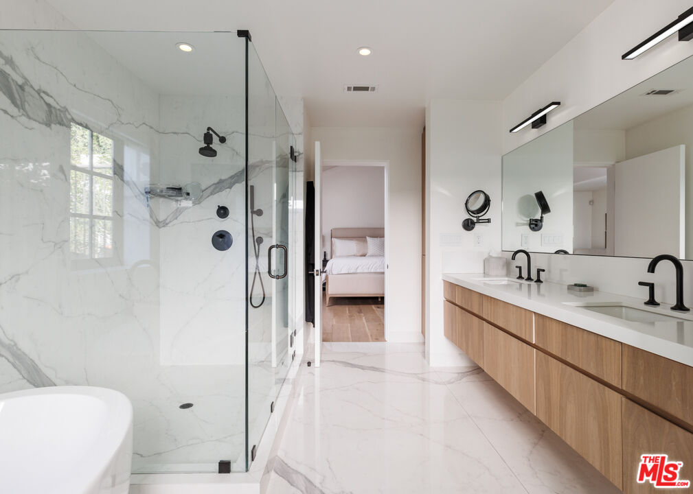1118 Tower Road Beverly Hills, CA 90210 - Photo 12 of 16 a bathroom with a double vanity sink mirror and shower
