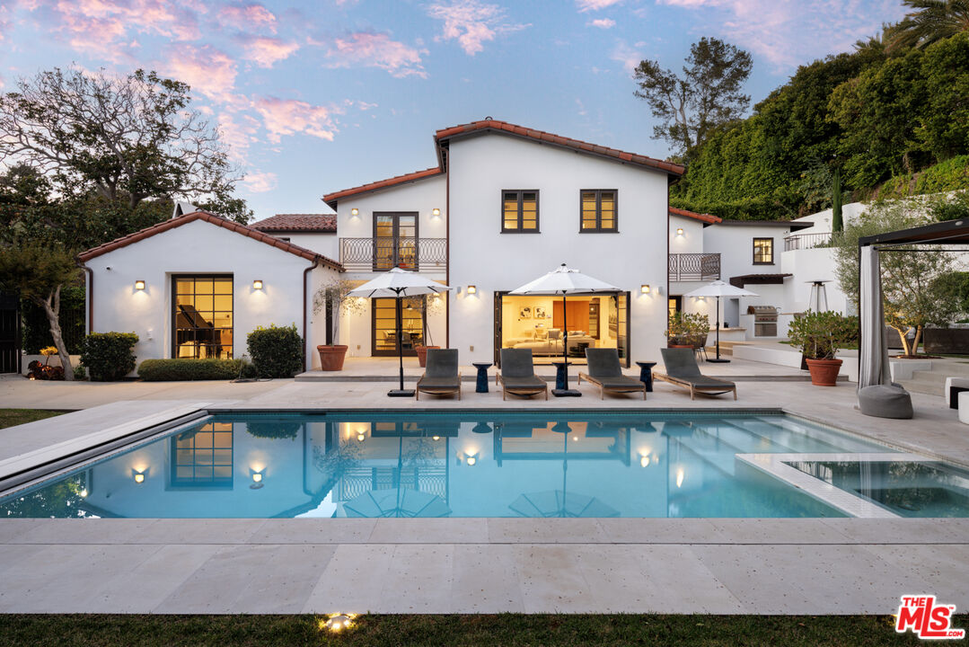 1118 Tower Road Beverly Hills, CA 90210 - Photo 13 of 16 a front view of a house with swimming pool and a yard
