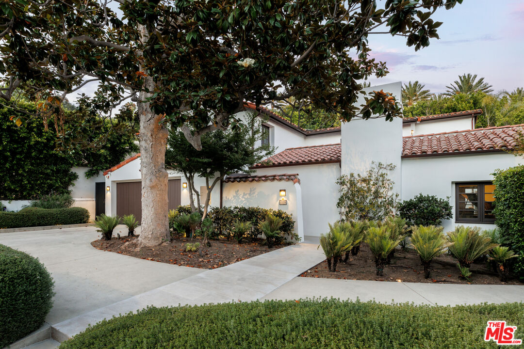1118 Tower Road Beverly Hills, CA 90210 - Photo 16 of 16 a view of a house with a yard and potted plants