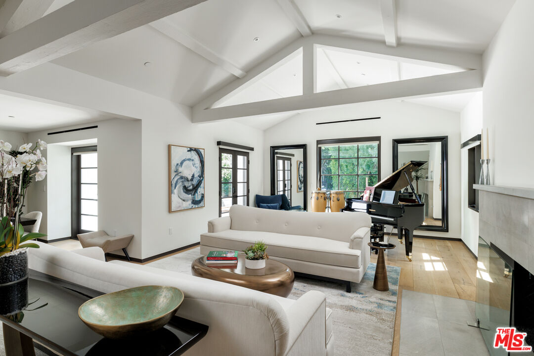 1118 Tower Road Beverly Hills, CA 90210 - Photo 3 of 16 a bedroom with furniture and a large window