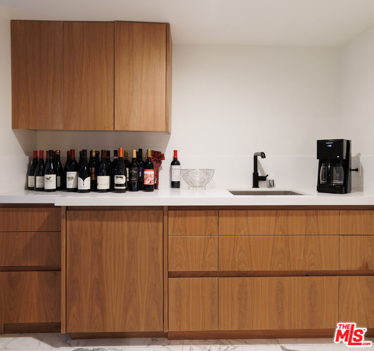 1118 Tower Road Beverly Hills, CA 90210 - Photo 9 of 16 a kitchen with a sink and cabinets