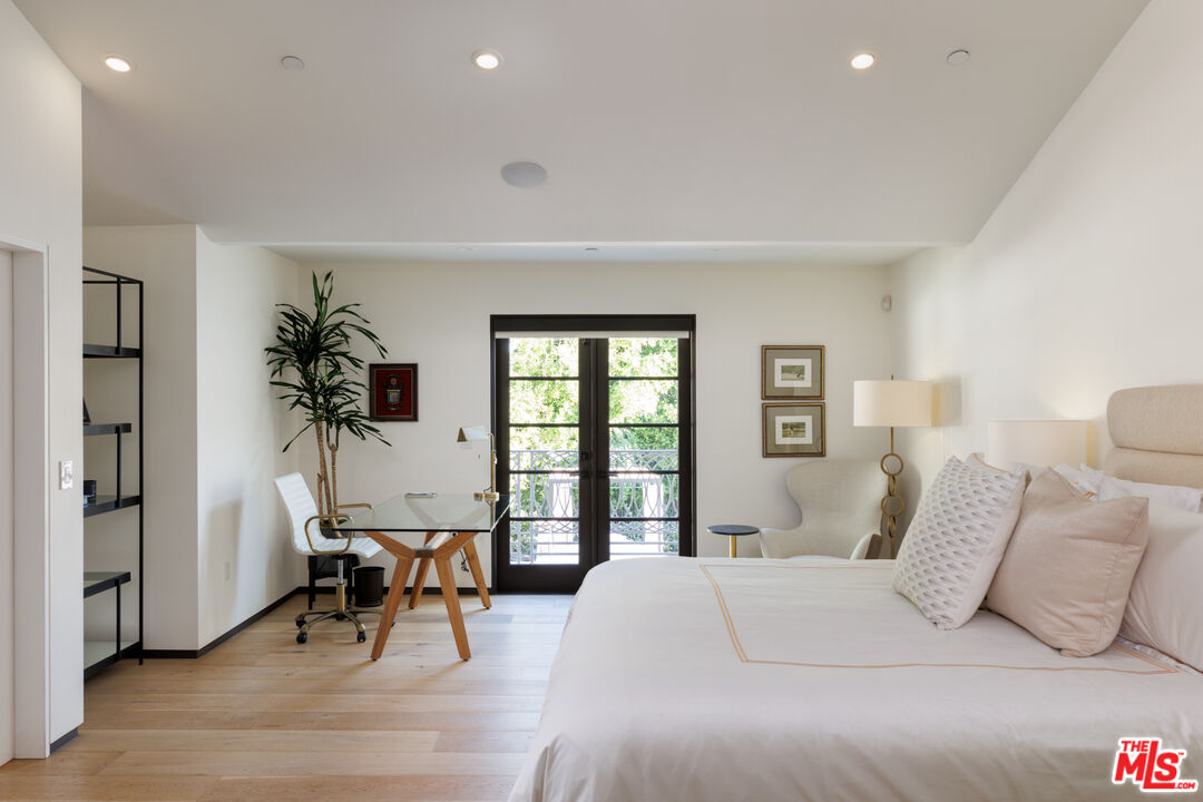 1118 Tower Road Beverly Hills, CA 90210 - Photo 10 of 16 a bedroom with a large bed and a potted plant