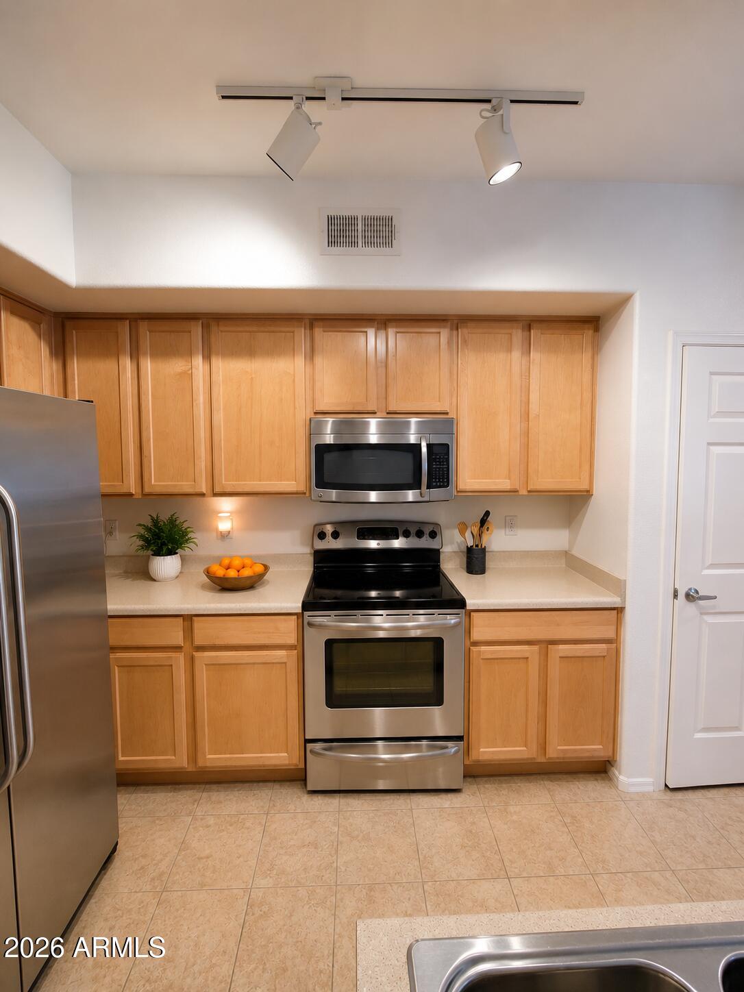 2150 West Alameda Road, Unit 1020 Phoenix, AZ 85085 - Photo 19 of 35 a kitchen with stainless steel appliances granite countertop a stove and a sink