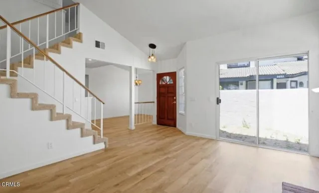 a view of entryway with wooden floor and stairs