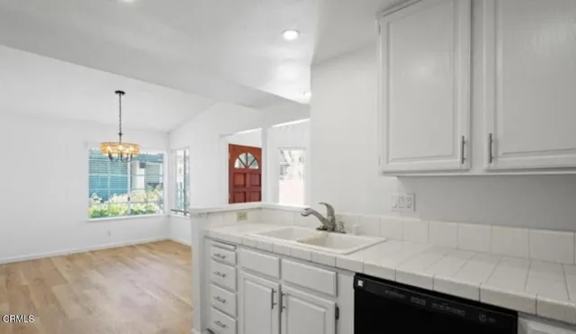 a kitchen with stainless steel appliances granite countertop a sink and a wooden cabinets