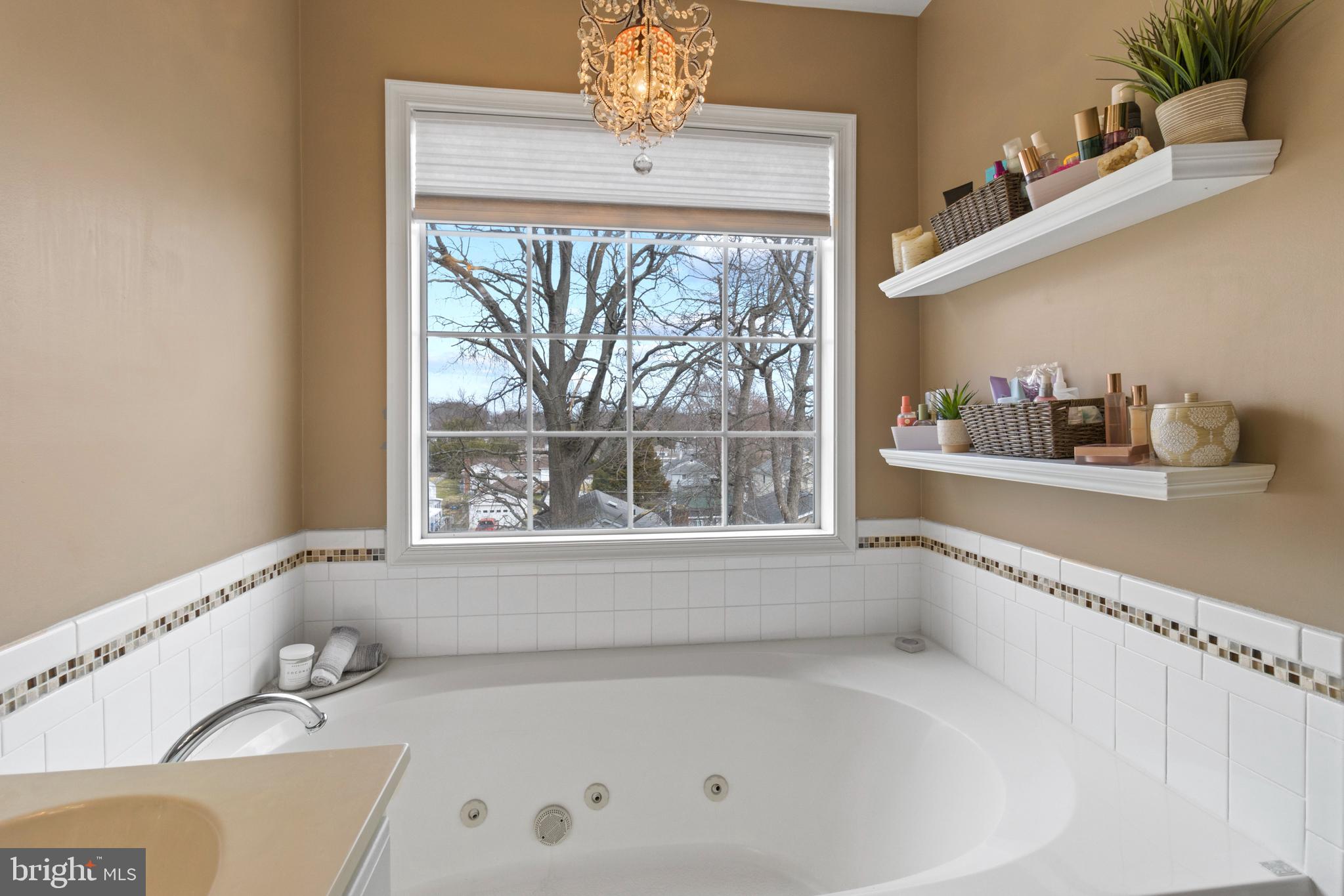 1615 Oldtown Road Edgewater, MD 21037 - Photo 23 of 35 a bathroom with a tub a sink and a window
