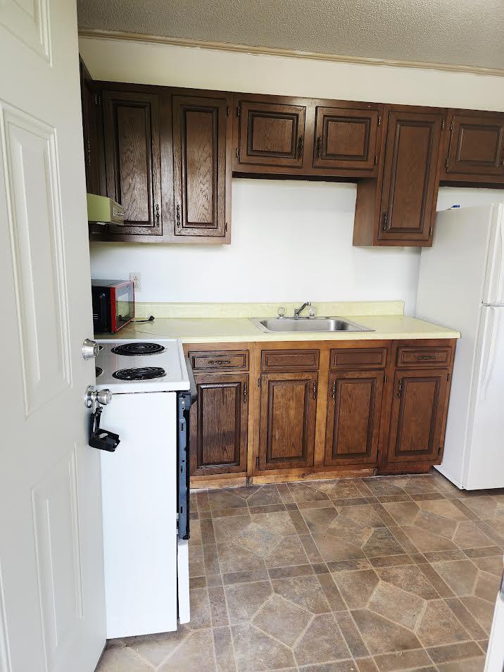 159 Bottom Road, Unit 4 Raven, VA 24639 - Photo 10 of 13 a kitchen with a sink and cabinets