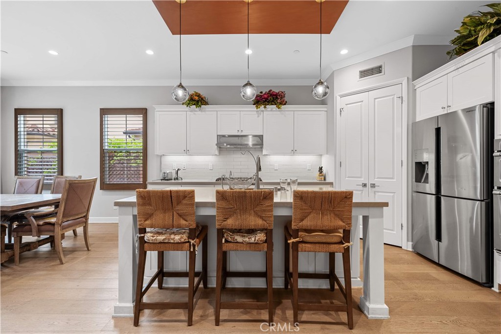 114 Guinness Irvine, CA 92620 - Photo 11 of 43 a dining table with chairs and kitchen view