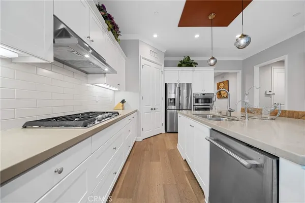 a large kitchen with stainless steel appliances granite countertop a stove and a sink