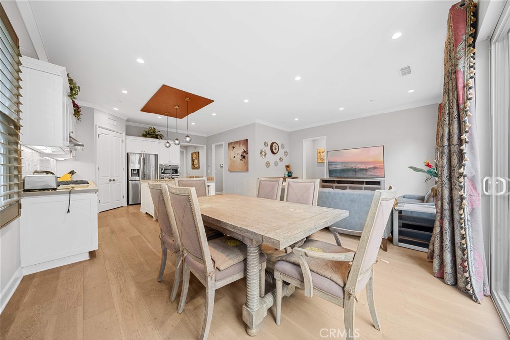 114 Guinness Irvine, CA 92620 - Photo 15 of 43 a kitchen with stainless steel appliances kitchen island granite countertop a dining table chairs and a refrigerator