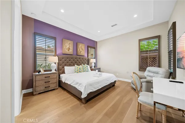 a spacious bedroom with a bed and a large window