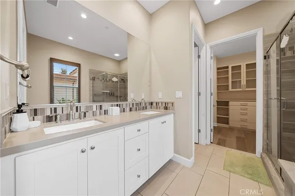 a bathroom with double sink and a mirror
