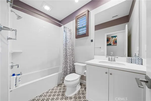 a bathroom with a sink toilet a shower and a mirror