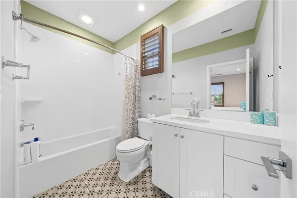 a bathroom with a sink toilet a shower and a mirror