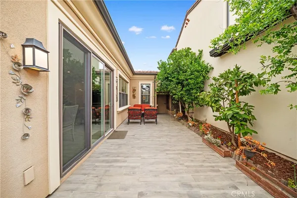 a balcony with furniture and a potted plant