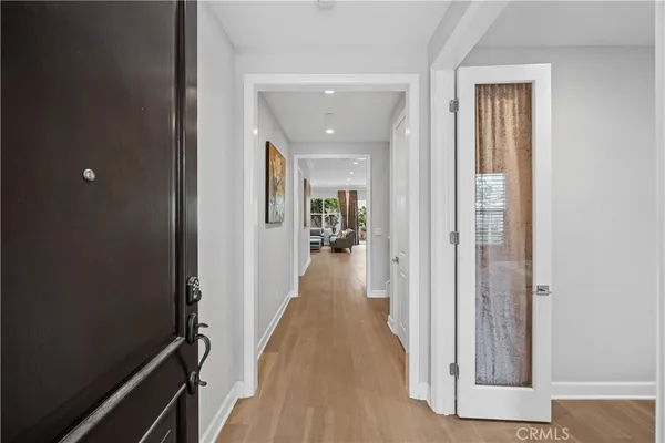 a view of hallway with wooden floor