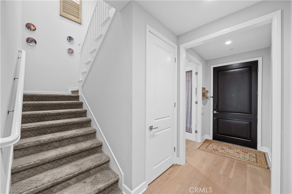 114 Guinness Irvine, CA 92620 - Photo 5 of 43 a view of entryway and hall with wooden floor
