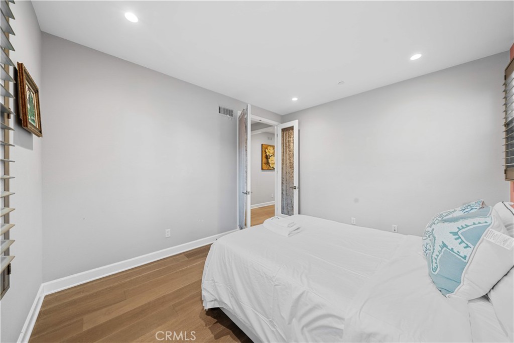 114 Guinness Irvine, CA 92620 - Photo 7 of 43 a bedroom with a bed and painting on the wall