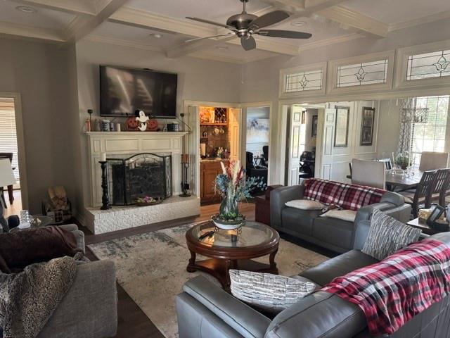 1762 Timber Ridge Circle Corinth, TX 76210 - Photo 6 of 26 Coffered ceiling with a ceiling fan, wood-finish flooring, white fireplace with hearth, and decorative transom windows