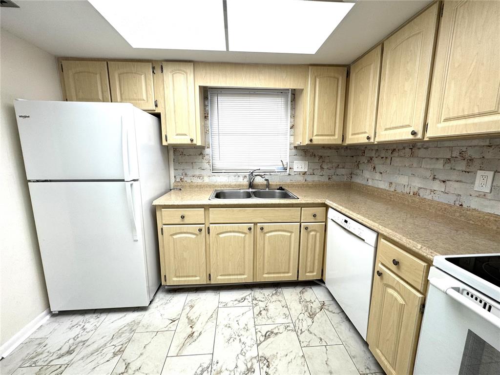 610 Indian Rocks Road North, Unit 103 Belleair Bluffs, FL 33770 - Photo 3 of 13 a kitchen with sink a refrigerator and a stove