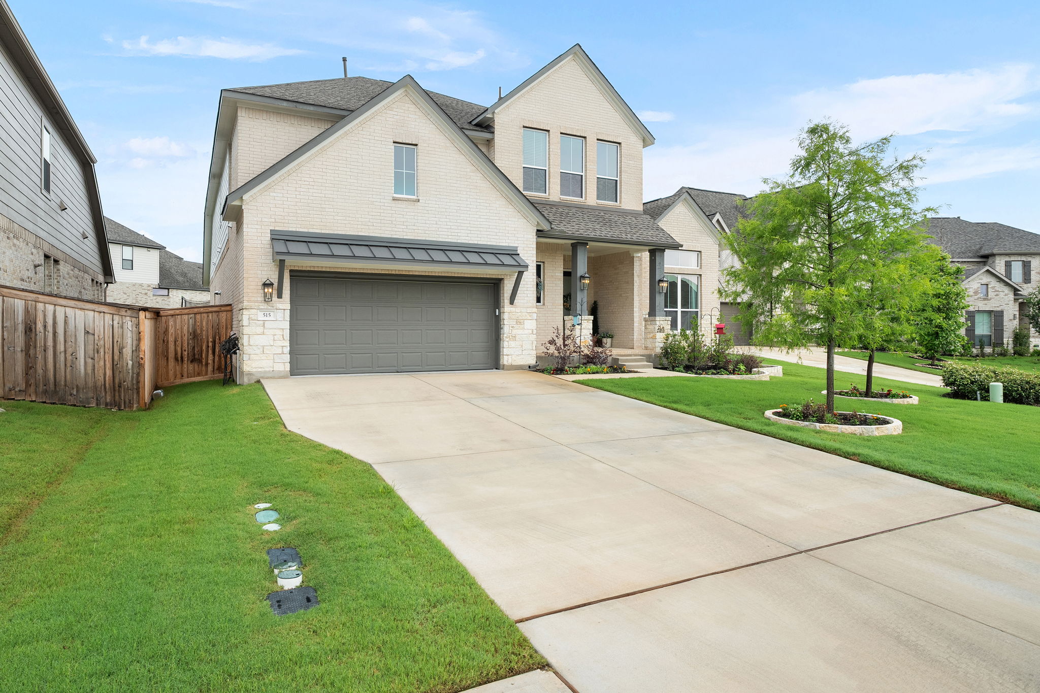 515 Watershield Cove Georgetown, TX 78633 - Photo 3 of 40 A cream brick facade and covered entryway invite you to this home featuring a two-car garage.