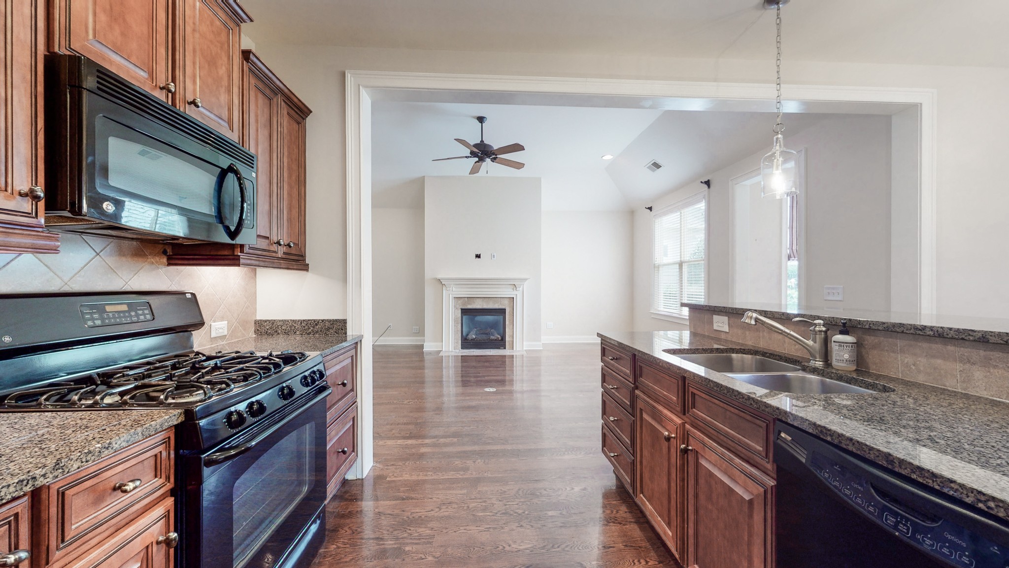 718 Pearre Springs Way Franklin, TN 37064 - Photo 8 of 46 a kitchen with granite countertop a sink dishwasher stove and oven with wooden floor