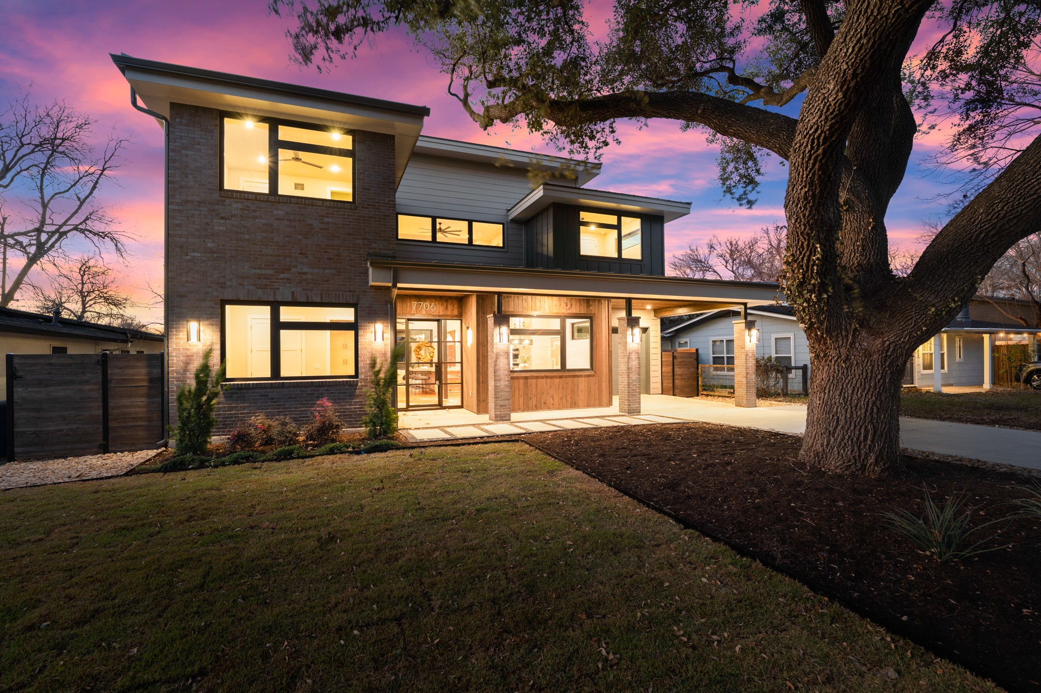 7706 Rutgers Avenue Austin, TX 78757 - Photo 1 of 35 View of front of house with brick siding, a porch, an attached carport, and concrete driveway