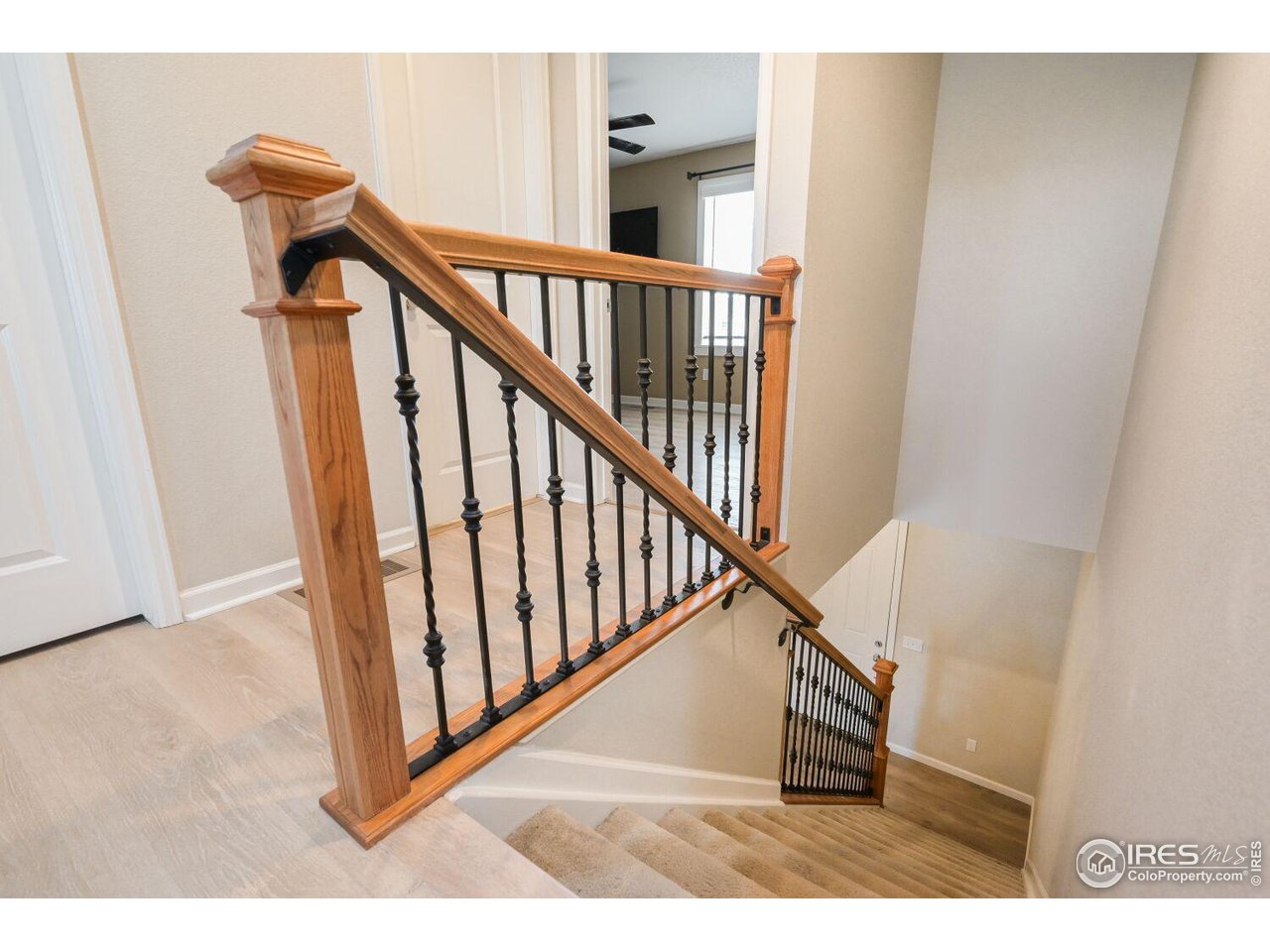 6112 Black Mesa Road Frederick, CO 80516 - Photo 15 of 45 a view of a hallway with wooden floor and stairs