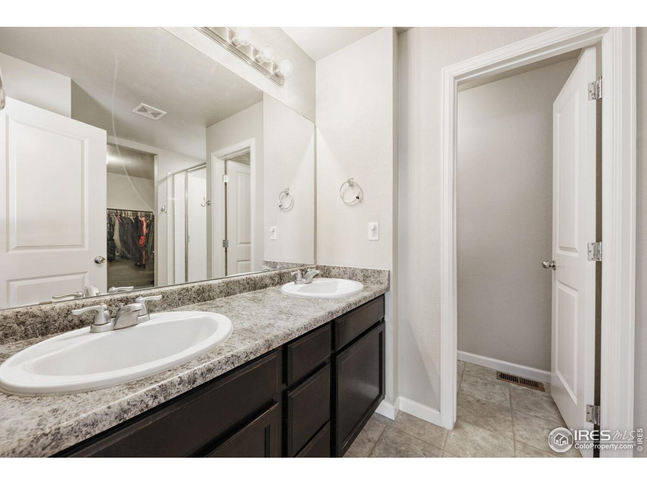6112 Black Mesa Road Frederick, CO 80516 - Photo 20 of 45 a bathroom with a granite countertop sink and a mirror