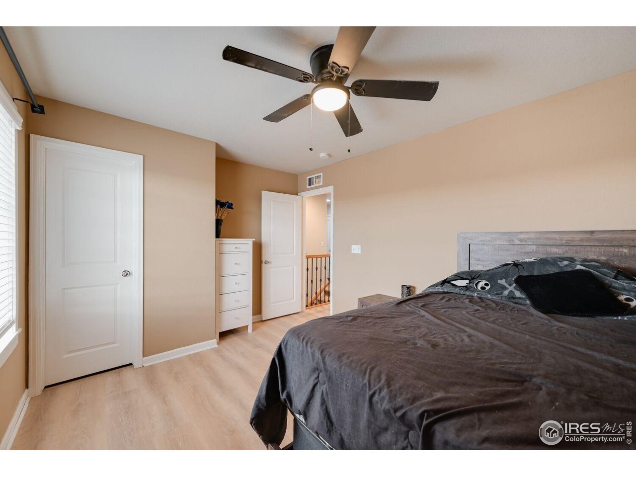 6112 Black Mesa Road Frederick, CO 80516 - Photo 25 of 45 a bedroom with a bed and a ceiling fan