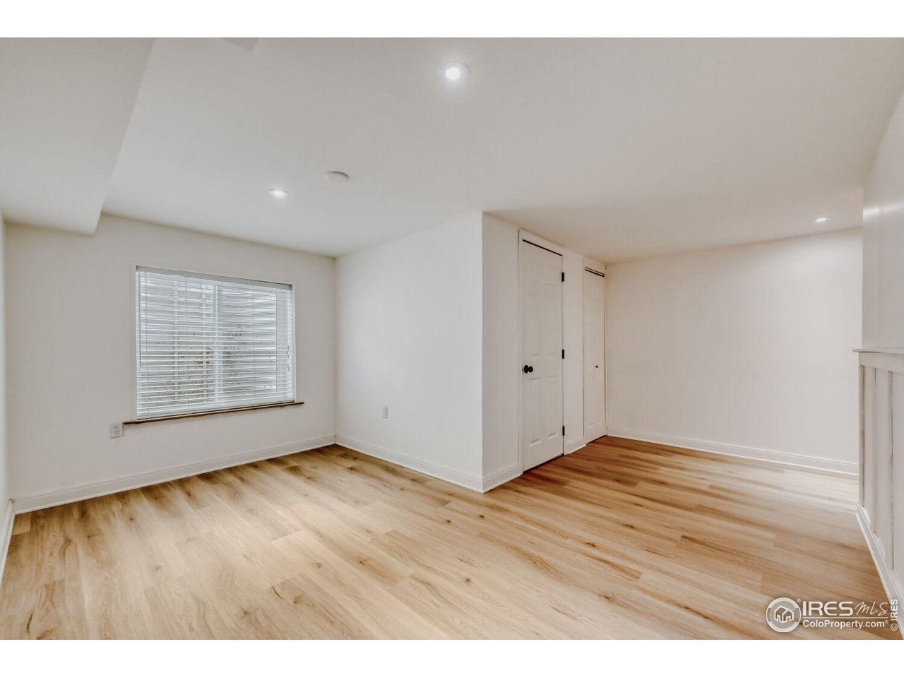 6112 Black Mesa Road Frederick, CO 80516 - Photo 29 of 45 a view of an empty room with wooden floor and a window