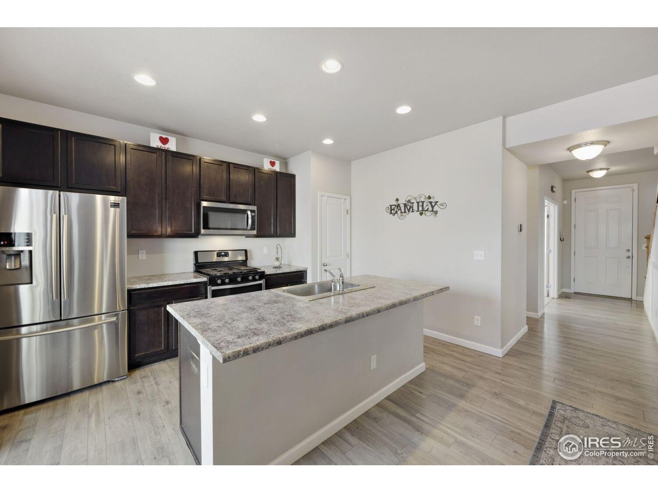 6112 Black Mesa Road Frederick, CO 80516 - Photo 5 of 45 a kitchen with stainless steel appliances granite countertop a sink refrigerator and microwave